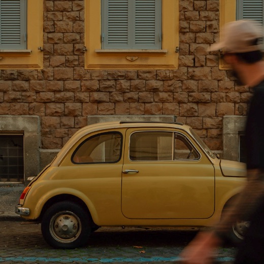 A vintage Fiat 500 on a street in Rome